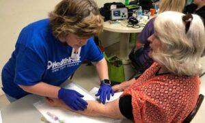 A photo of a Valley-Wide nurse preparing to draw blood from a patient.